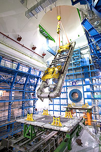 The first coil of the toroid magnet is lowered into the ATLAS cavern