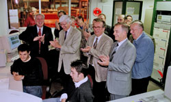 Members of CERN management applaud a successful test of the first full-scale LHC dipole along with representative of the INFN and Ansaldo Energia